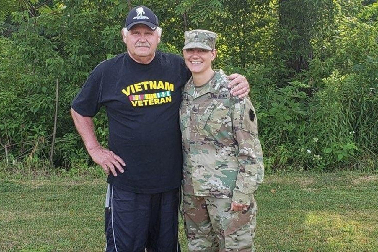 man standing with daugher in military uniform