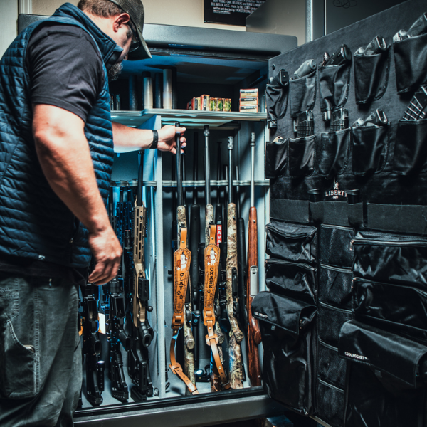 man looking inside a gun safe
