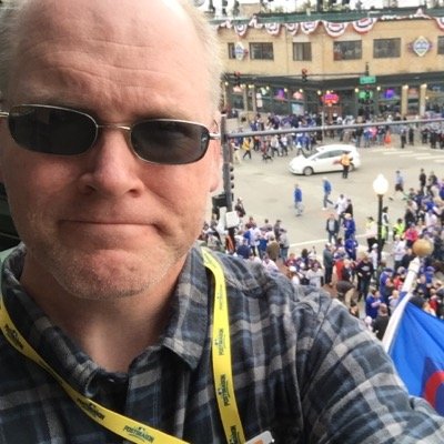 man taking a selfie with a large crowd behind him