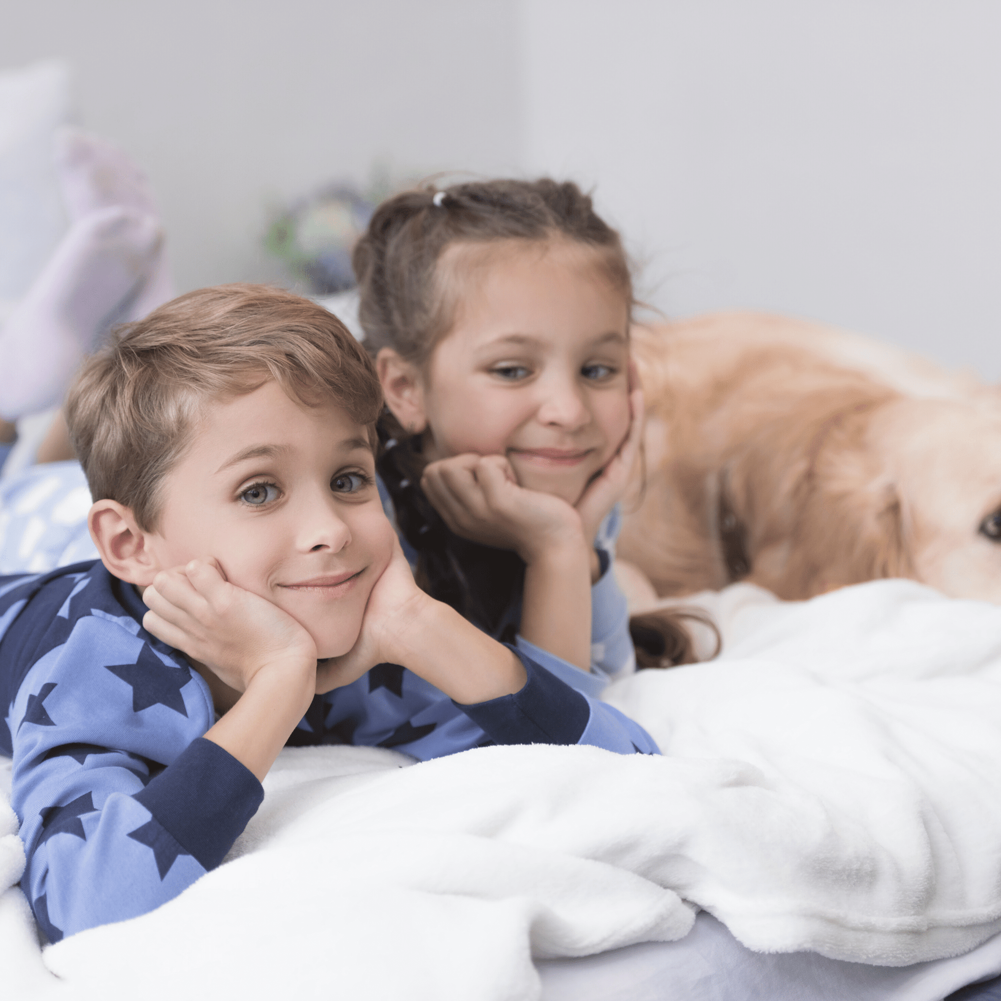 kids and a dog sitting on bed
